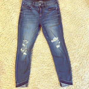 Express distressed uneven hem jeans